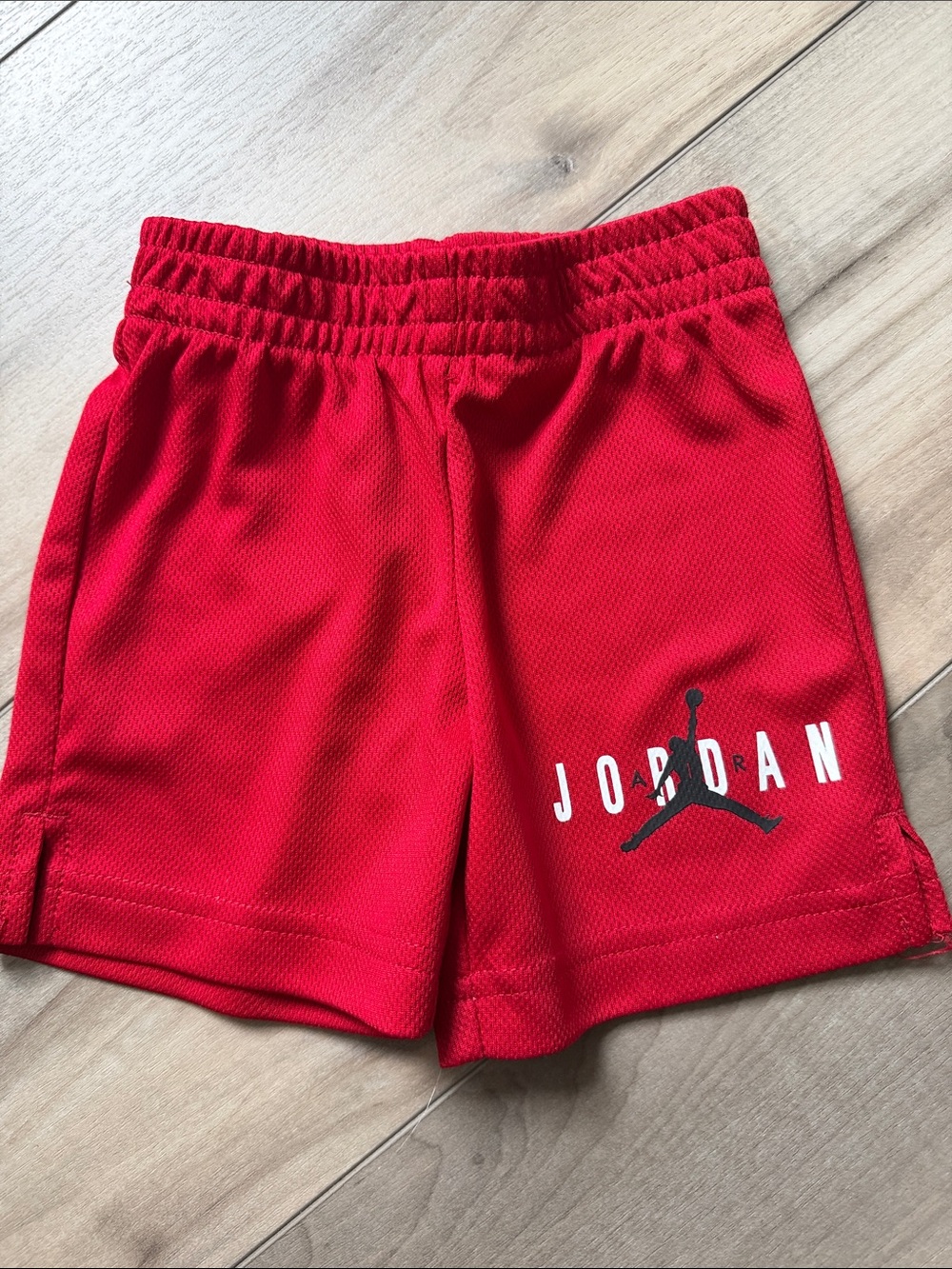 Jordan Red Kids Athletic Mesh Shorts with Black Jumpman. 2T